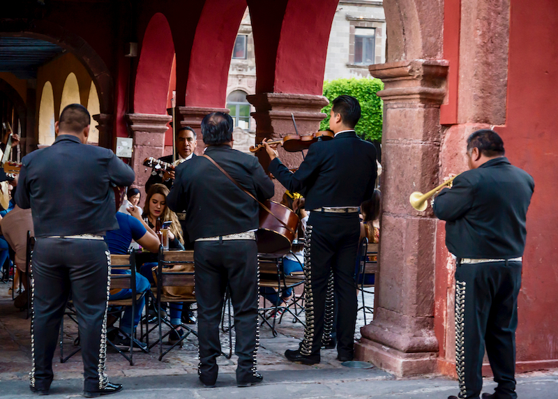 mariachi musicians serenading diners