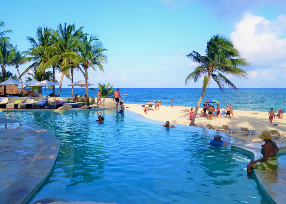 Hotel with pool on beach in Playa del Carmen.