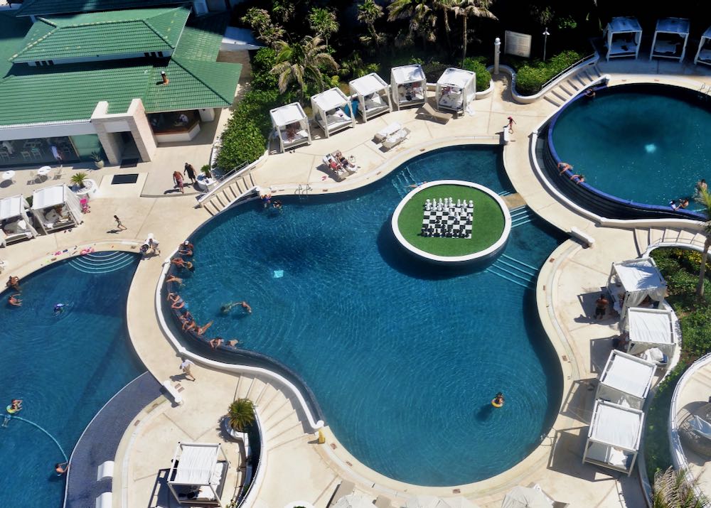 Swimming pool at Cancun resort with cabanas. 