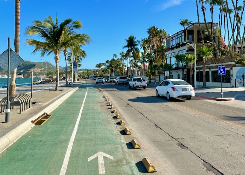 A green two-lane bike lane next to the road.