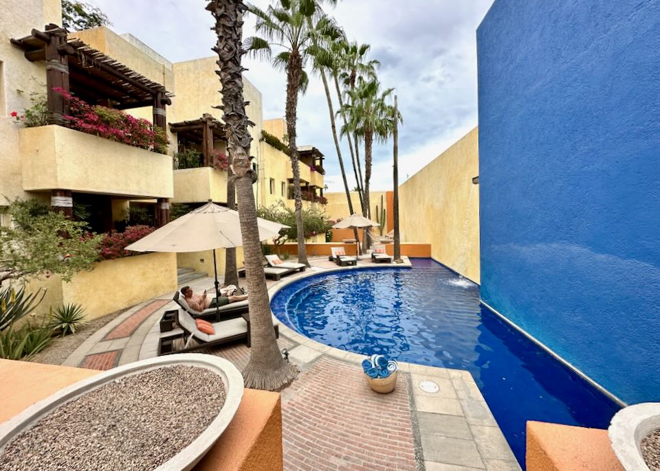 A man sits by the pool.