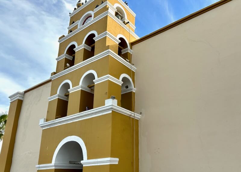 A mustard-colored painted church.