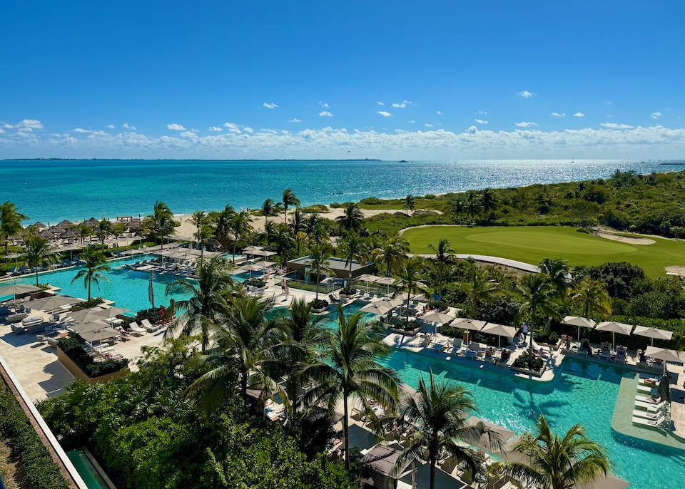 An enormous pool next to a golf course in front of a beach at Atelier resort in Playa Mujeres near Cancun.