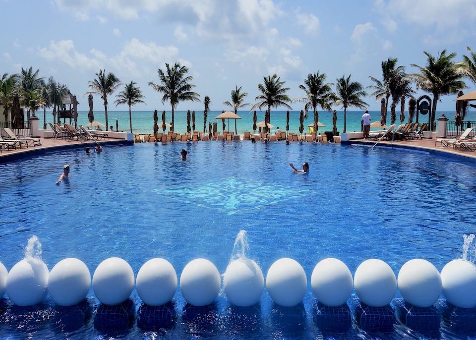 A direct view of a large pool facing the ocean at Grand Residences in Cancun.