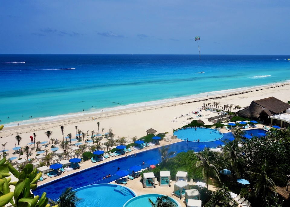 One long pool with three round pools set inside the main pool behind the beach at Live Aqua resort in Cancun.