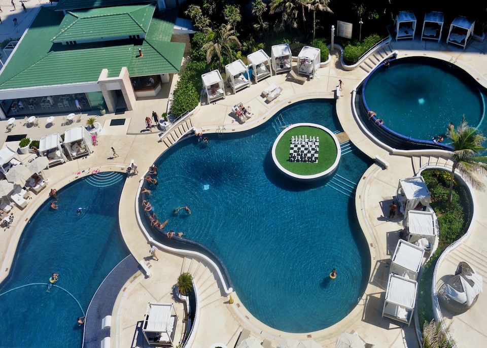 View looking down on three, tiered pools at Sandos resort in Cancun.