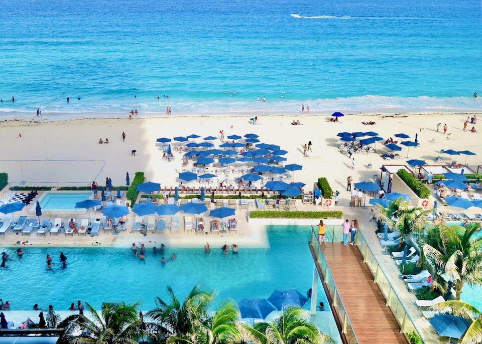 Two side-by-side beachfront pools at Secrets the Vine resort in Cancun.