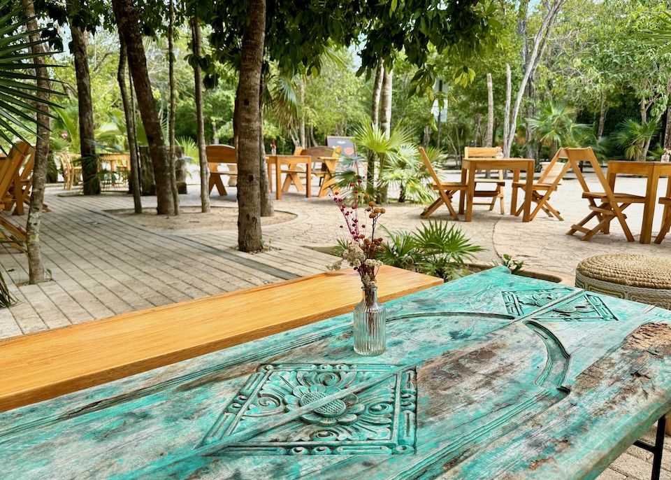 A table made from an antique door at a sidewalk cafe in the Aldea Zama neighborhood of Tulum.