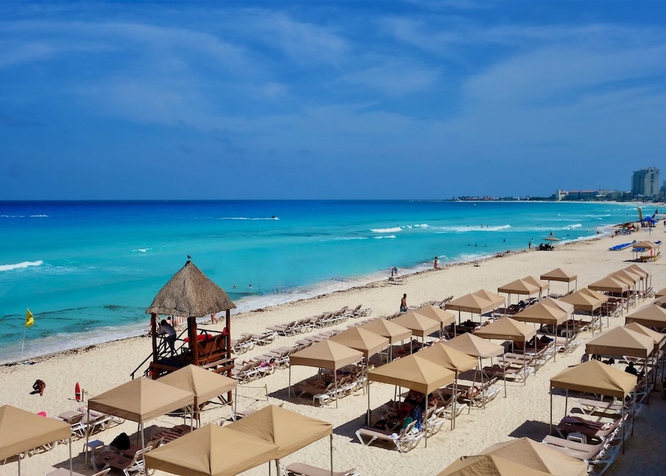 Sunbeds and cabanas line the beach at Crown Paradise Club in the South Hotel Zone of Cancun.