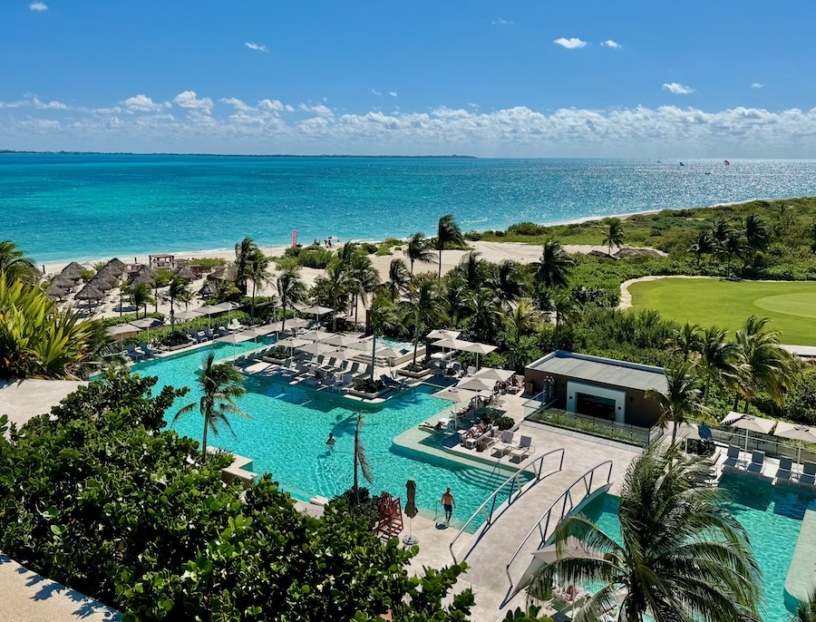 A pool set behind the beach next to a golf course at Atelier resort in Playa Mujeres near Cancun.