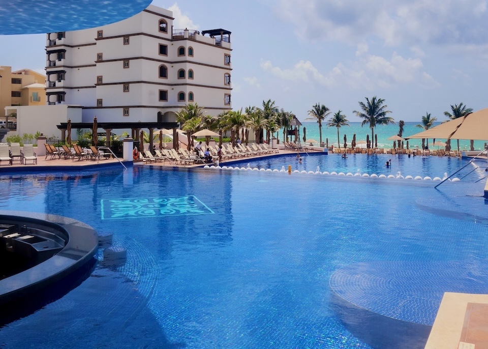 A two-tiered pool facing the ocean at Grand Residences in Riviera Cancun.