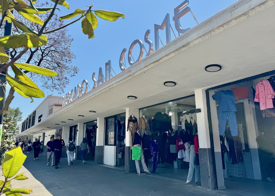 Outside the modern Mercado San Cosme with shops selling clothing in the San Rafael neighborhood.