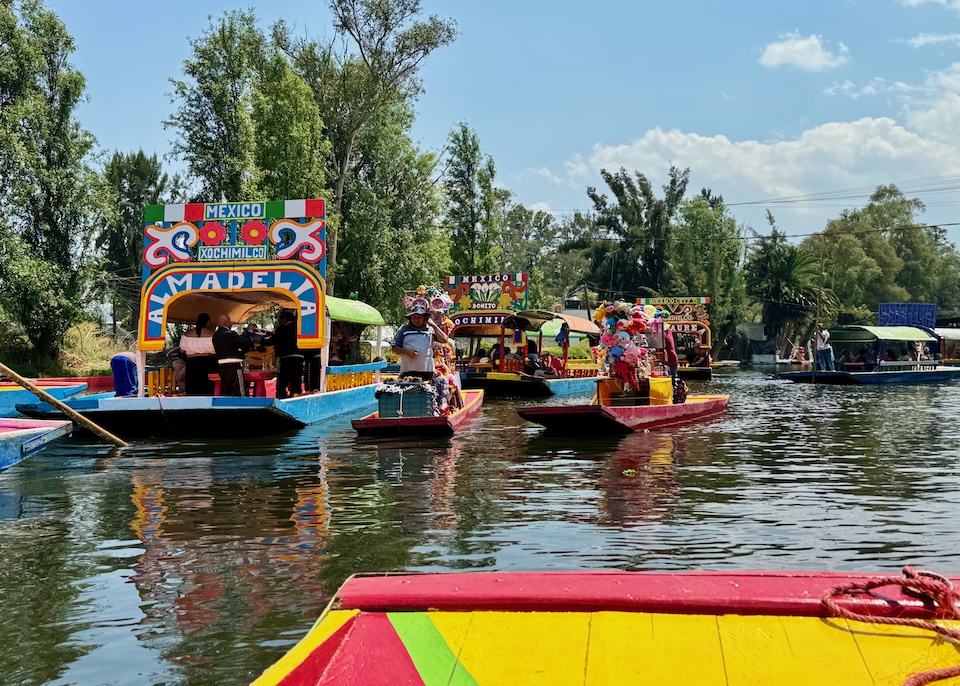 Brightly festooned, flat-bottomed, party boats float in the canals of Xochimilco on the south side of Mexico.