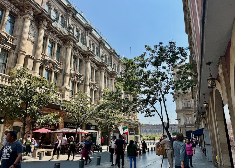 Neoclassical façade of the Gran Hotel Ciudad de México with four stories of columns, arches, and elaborate ornamentation on a busy shopping street in Centro Histórico, Mexico City.