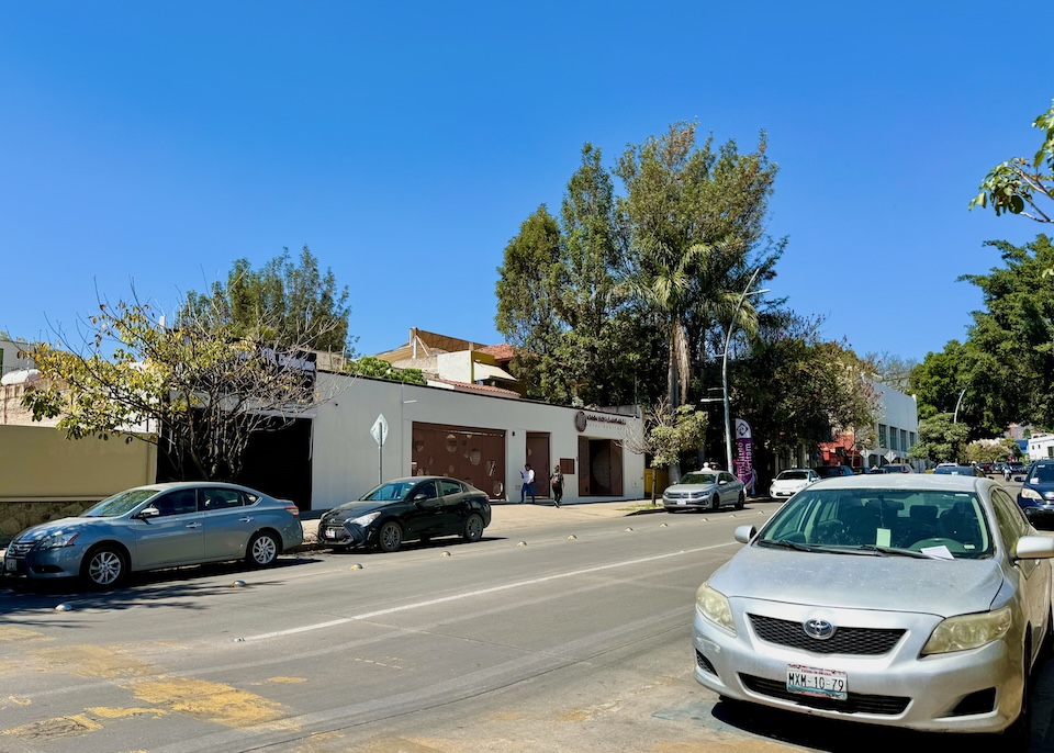 A typical, neutral-color, tree-lined street in the low-key Reforma neighborhood of Oaxaca.