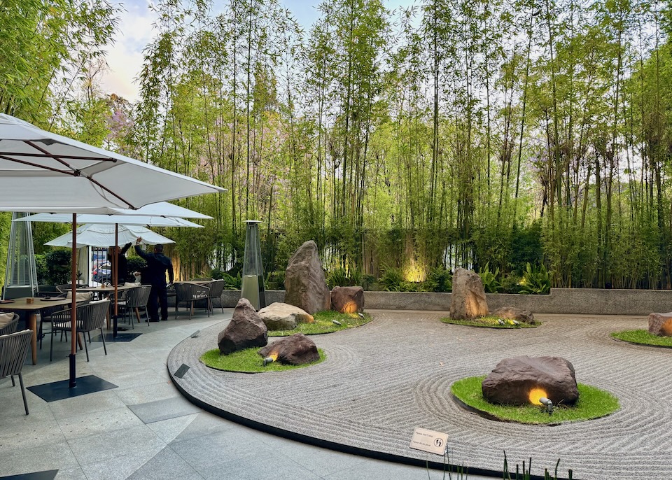 A carefully raked Zen-garden surrounded by a bamboo garden plus a row of tables in Yoshimi Restaurant at the Hyatt Regency in Mexico City.