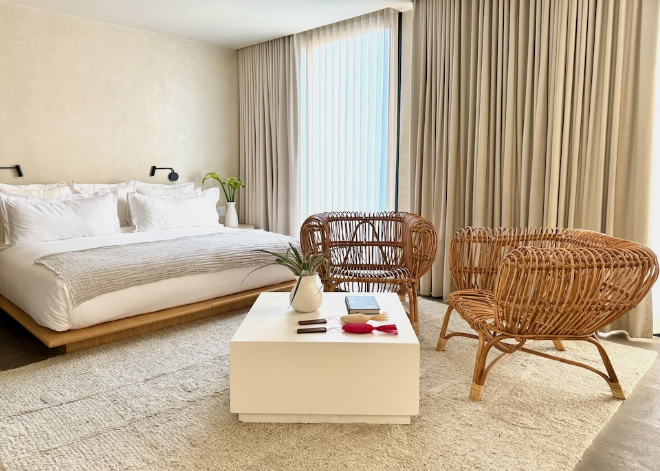 Contemporary, luxury room in white, neutral, and wood tones with a floor-to-ceiling window at Octavia Casa in Mexico City.